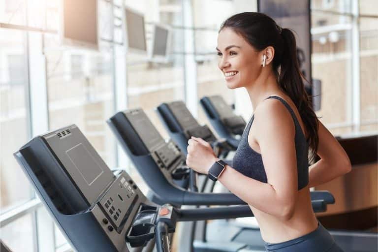 woman in sportswear is running on a treadmill