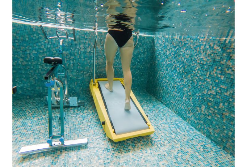 Young woman jogging on an underwater treadmill