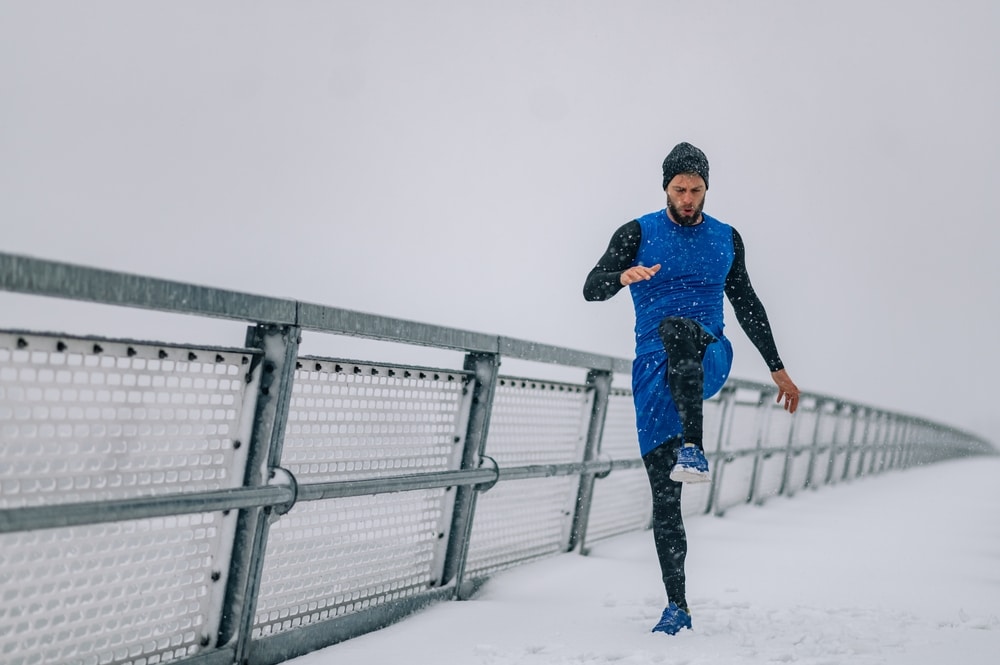 Man-stretching-and-warming-up-before-a-run-in-the-snow