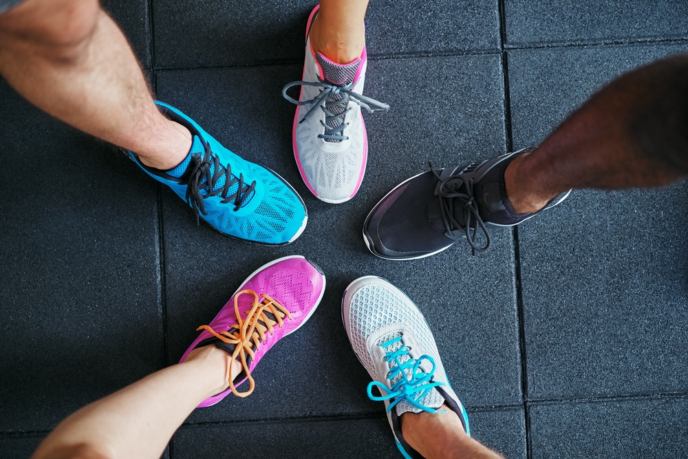 High-angle-view-of-a-group-of-people-wearing-different-running-shoes