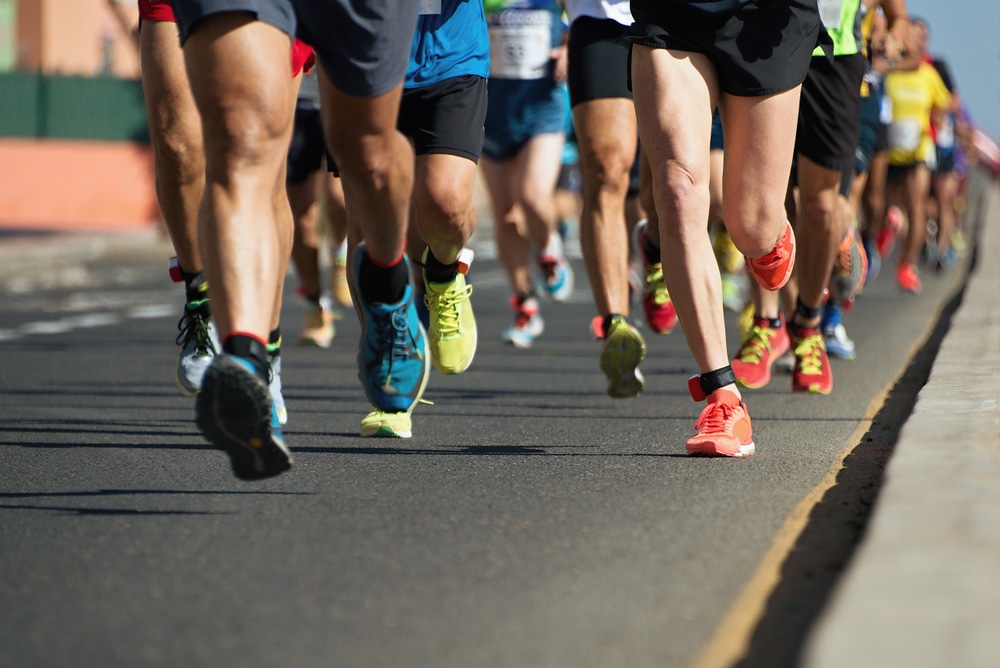 Group of runners running down road in a race